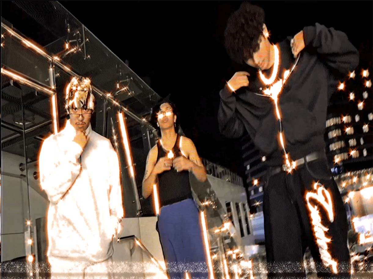 Three members of 404CREW posing outdoors at night with sparkling neon light effects and animated glow accenting clothing and accessories.